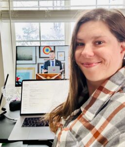 Women sitting in front of her laptop listening to State of the Word
