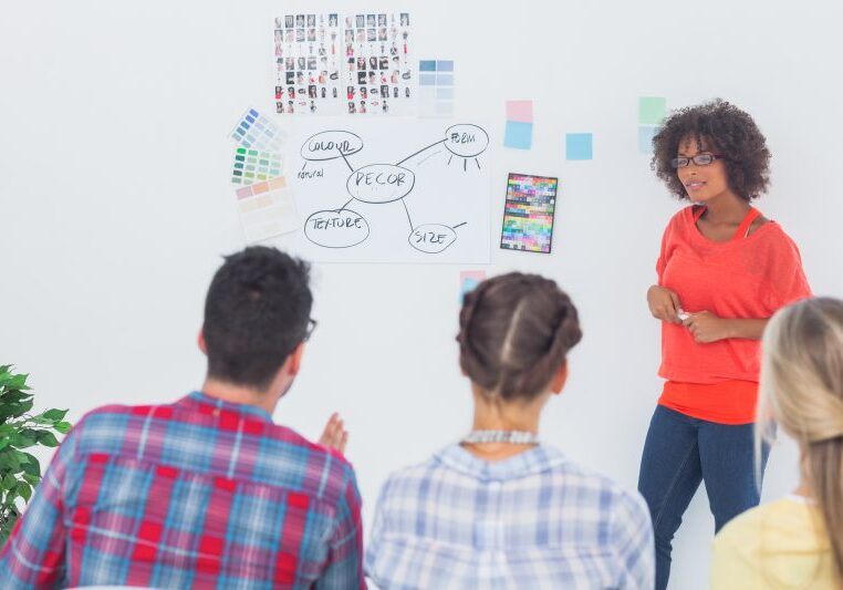 Interior designers looking at a wall during a brainstorming
