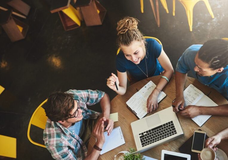 a group of people working with a computer
